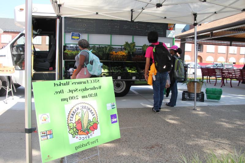 Entrance of Farmers' Market with Sign and Vegetable Stand